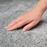 Woman,Touching,Grey,Carpet,,Close,Up.,Close,Up,Of,Hand