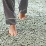 Barefoot,Woman,Walking,On,Green,Carpet,At,Home,,Closeup