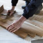 Experienced,Worker,Installing,Parquet,Boards,In,Glue,In,New,House